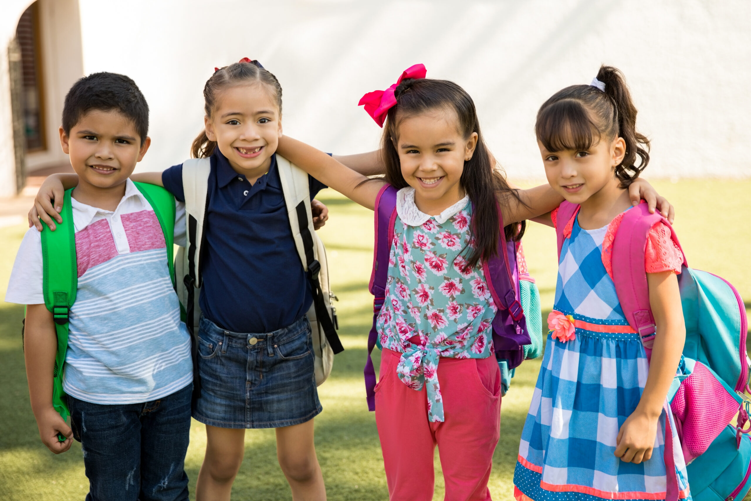 Portrait of a group of friends hanging out outdoors while going to preschool together